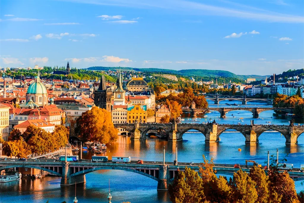 Malerische Panoramaaufnahme der historischen Prager Altstadt mit der Karlsbrücke und der im Hintergrund gelegenen Prager Burg, die bei strahlendem Sonnenschein die Moldau überspannen.