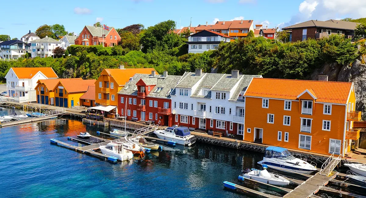 Der Hafen von Haugesund in Norwegen mit Booten am Wasser und Blick auf die Uferpromenade.
